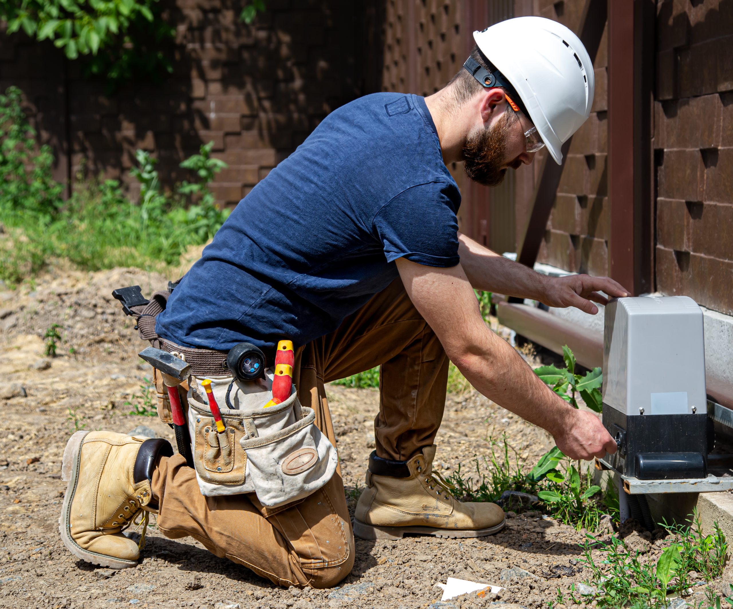 Electrician Builder in overalls with an tool servicing the fuselage industrial switchboard. Key Benefits of Sewer Pipe Inspections